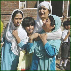 A volunteer carries a child injured by the earthquake at a local hospital in Islamabad, Pakistan, Saturday. (AP/Anjum Naveed) 